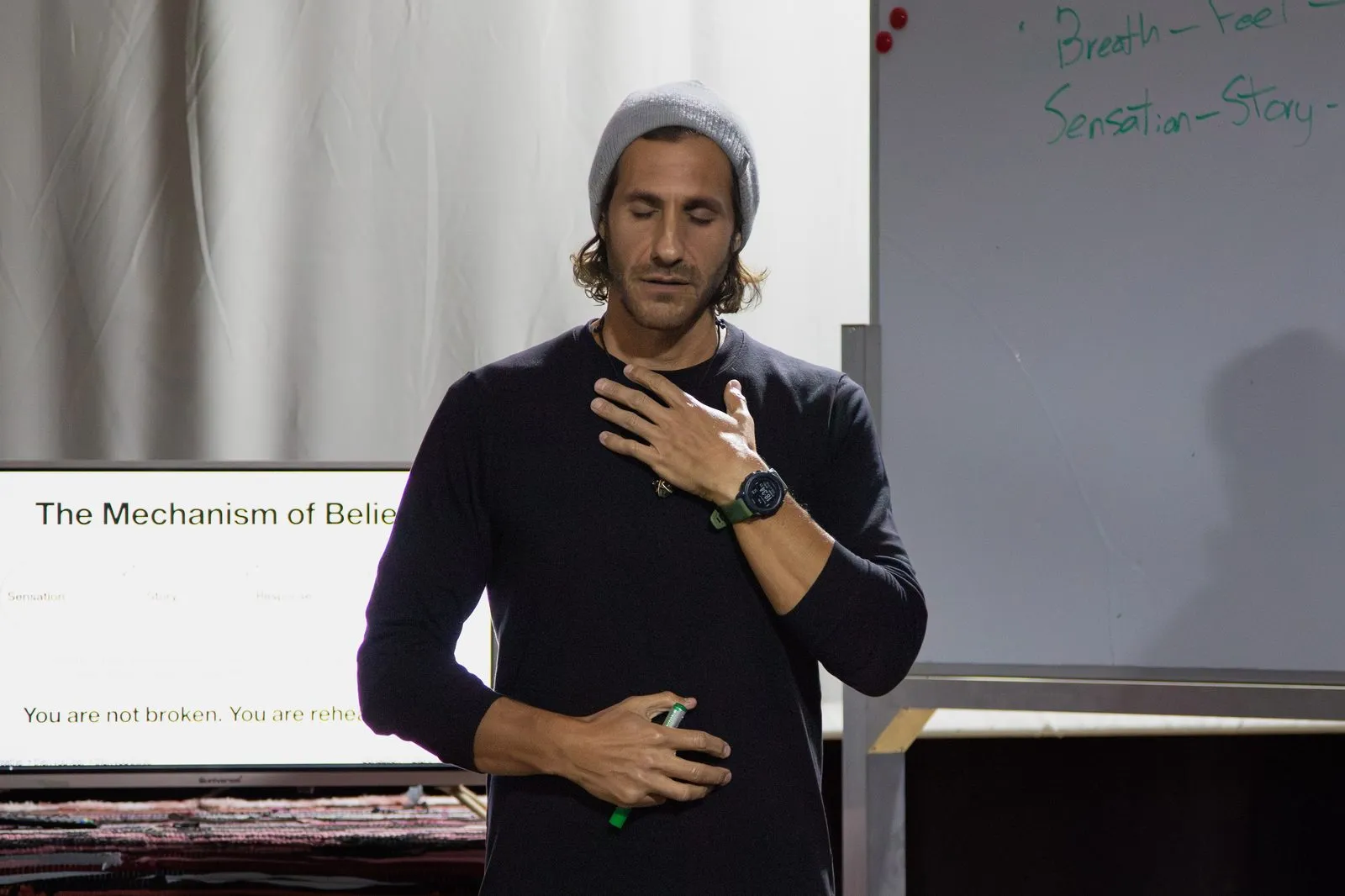 Aaron demonstrating awareness with one hand on his chest and the other on his stomach