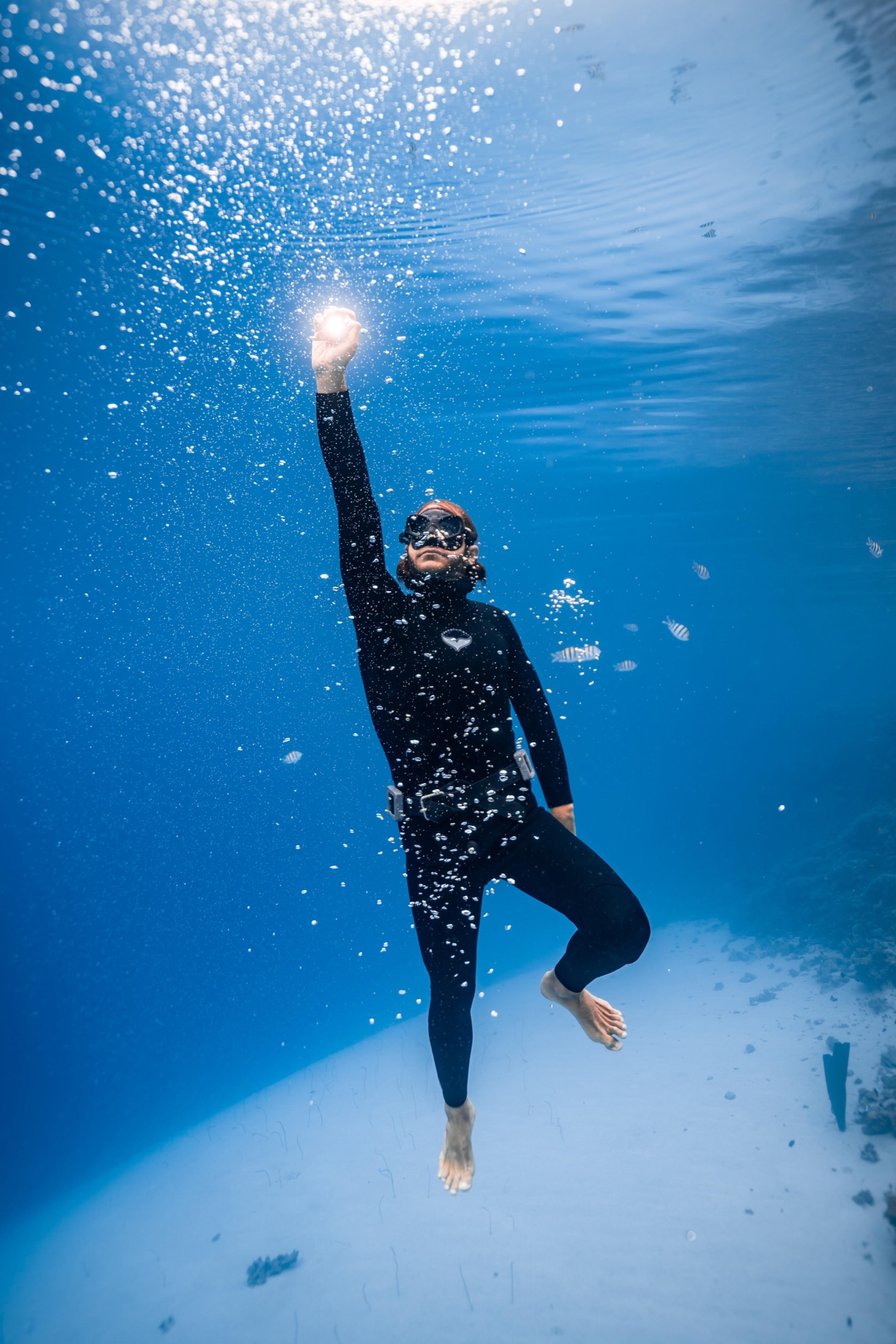 Aaron Fisher rising toward the light through blue water